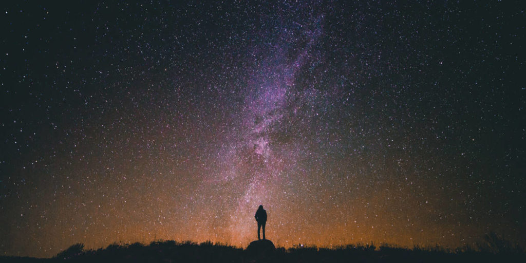 Person Looking Up At Starry Night Sky - Improve Your Sleep with Natural Health